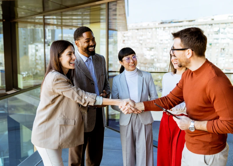 Business team shaking hands outdoors